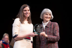 Melissa Heim accepts the award from Mara Kieser, assistant dean at the School of Pharmacy.